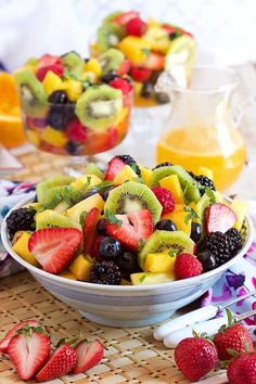 fruit salad in a bowl with strawberries, kiwis, and oranges