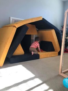 a small child is playing in a play house