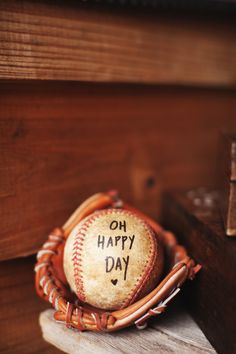 a baseball in a catchers mitt with the words oh happy day written on it