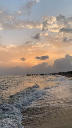 the sun is setting over the water at the beach