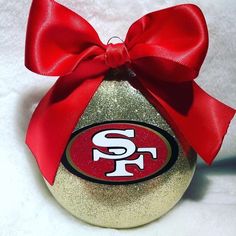 a san francisco football ornament with a red bow