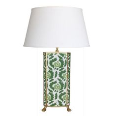 a green and white lamp with a white shade on the base, sitting next to a white lampshade