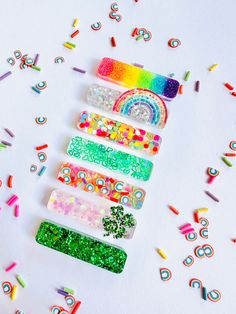 several different types of hair clips with confetti on them