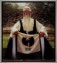 an old man sitting on a bench holding a banner