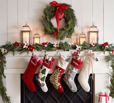 christmas stockings hanging from a mantel over a fireplace