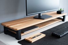 a computer desk with a keyboard, mouse and monitor