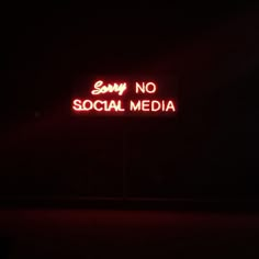 a neon sign that says sorry no social media