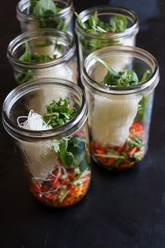 four mason jars filled with different types of food