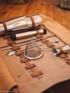 an assortment of kitchen utensils laid out on a piece of brown parchment paper