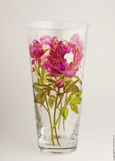 a glass vase with flowers painted on it