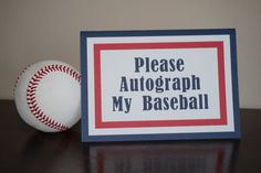 a baseball sitting on top of a table next to a sign that says please autograph my baseball