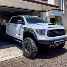 a white truck parked in front of a building