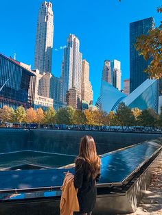 a woman is looking at the city skyline