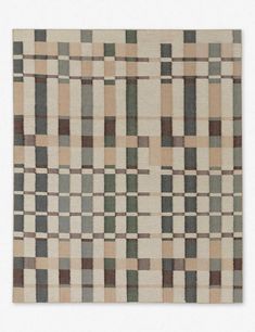 an area rug with different colored squares and lines on the ground, in neutral colors