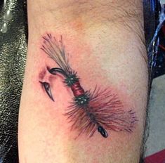 a tattoo on the leg of a man with an arrow and fireworks coming out of it