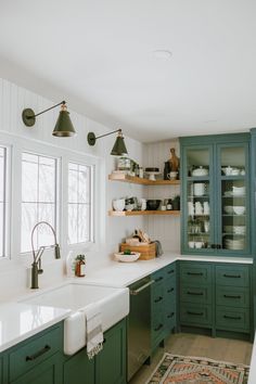 the kitchen is clean and ready for us to use it's green cabinetry