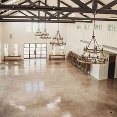 an empty room with chandeliers hanging from the ceiling