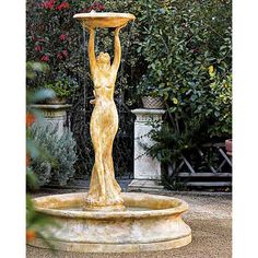 a fountain with a woman holding a birdbath