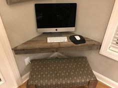 an apple computer sitting on top of a wooden desk