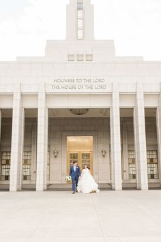 a bride and groom are standing in front of the doors of an old courthouse building