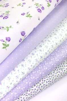 four different types of fabric with flowers and dots on them, all in pastel colors