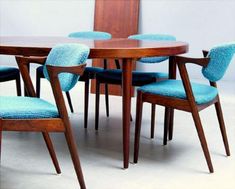 a wooden table with blue chairs around it