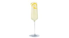 a tall glass filled with liquid and topped with a slice of lemon next to a white background