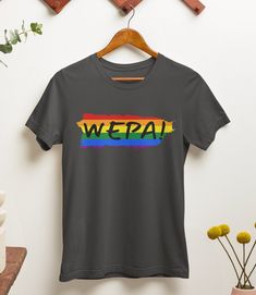 "WEPA! Express your Puerto Rican heritage and showcase your pride with this unique and meaningful unisex t-shirt. Whether you're attending a pride event, exploring your cultural roots, or simply adding a vibrant touch to your everyday outfits, this shirt is a statement piece that will make heads turn and spread joy wherever you go.  Available in a range of sizes, our Rainbow \"WEPA!\" T-Shirt is designed to fit all genders comfortably. It also makes a thoughtful gift for your Puerto Rican friends, family, or loved ones who appreciate colorful expressions of identity and heritage. \"WEPA!\" is not just a word but a contagious feeling of excitement and celebration. Add this joyful t-shirt to your collection today and let your vibrant spirit shine through! .: 100% Airlume combed and ringspun Pride Short Sleeve T-shirt With Letter Print, Pride Letter Print Short Sleeve T-shirt, Rainbow Crew Neck T-shirt For Pride, Pride Slogan T-shirt With Short Sleeves, Pride Slogan T-shirt Short Sleeve, Pre-shrunk Crew Neck T-shirt For Pride, Pride Screen Print Crew Neck T-shirt, Pride Letter Print Crew Neck T-shirt, Pride Graphic Tee With Slogan