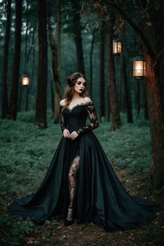 a woman in a black dress is standing in the woods with her hands on her hips