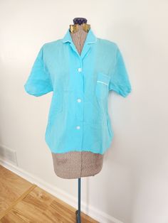 This vintage shirt is a fun addition to any wardrobe. Lady McKnight Wash 'N Wear 100% cotton The shirt features a crinkle fabric in a retro shade of blue. The fabric is thin by design and an undershirt may be needed. Shoulder to hem length: 22.25 inches Sleeve length: 7 inches Chest: 41 inches This shirt is in great vintage condition. There is a tiny mark to the left shoulder (see last photo). Feel free to send me any questions! Crinkle Fabric, Vintage Lady, Style Shirt, Vintage Shirt, Womens Casual Outfits, Cotton Blouses, Vintage Shirts, Bowling, Piece Of Clothing