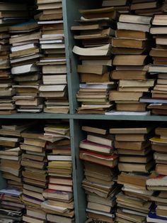 stacks of books are stacked on top of each other