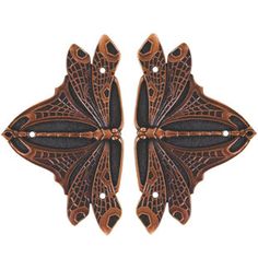 two brown and black butterfly shaped brooches on a white background, one is facing the opposite direction