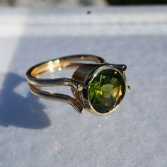 14K solid yellow gold ring by ICCHA with 10mm round peridot.  Size 5.75. Modern Peridot Rings For Anniversary, Modern Yellow Gold Peridot Jewelry, Modern Green Birthstone Ring, Gold Peridot Rings For Formal Occasions, Peridot Round Birthstone Ring For Formal Occasions, Formal Round Peridot Birthstone Ring, Formal Peridot Birthstone Ring For May, Formal Peridot Birthstone Ring, Green Jewelry With Round Cut Tension Setting