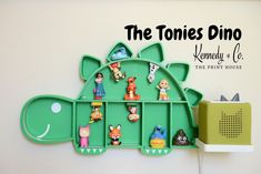 there is a green shelf with toys on it and the words, the tones dino