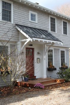 a white house with a black metal roof