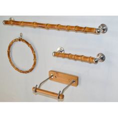 three pieces of wood and metal hanging on a white wall next to a circular object