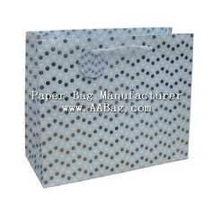 a white paper bag with polka dots on it