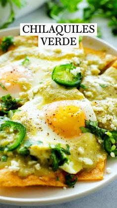 an egg and cheese enchilada on a plate with the words, chilaques verde