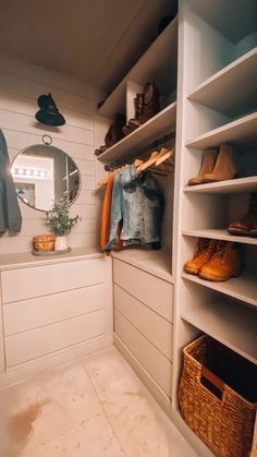 a walk - in closet with white shelving and shelves filled with shoes, hats, and other items