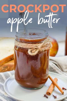 an apple butter in a glass jar with cinnamon sticks on the side and text overlay that reads crockpot apple butter