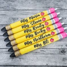 four pencils with writing on them sitting next to each other