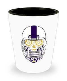 a blue and white shot glass with a skull wearing a football helmet on the side