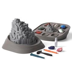 a sand castle and some markers are on the table with it's lid open