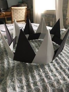 a paper crown sitting on top of a bed