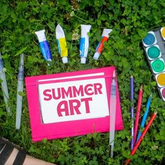 Paint palette, paint tubes, brushes, colored pencils and a sketchbook on green grass Summer Art Ideas, Make Art