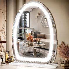 a living room filled with furniture and a large mirror in the middle of it's wall