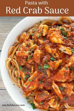 pasta with red crab sauce in a white bowl on top of a wooden table and text overlay that says pasta with red crab sauce