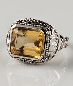 *Size--6 *Weighs-4.2 grams *Genuine, Emerald Cut, Natural Citrine in a solid sterling silver, filigree setting. *Gorgeous floral detailing in the filigree. *Stamped 925. *Dates from the 1990s. *Condition-Excellent for its age. Minor signs of wear & patina.  *Great ornate filigree design typical of the Flapper Era. *Makes a marvelous statement on the finger. *Heirloom quality ring you will enjoy for generations to come! *You will receive the exact item in the pictures. All professional cleaning w Flapper Era, Floral Filigree, Step Cut, Deco Floral, Sterling Silver Filigree, Filigree Design, Natural Citrine, Filigree Ring, Silver Filigree