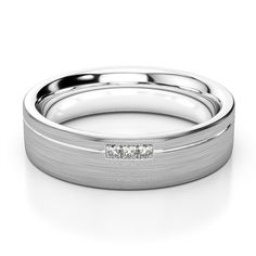 a white gold wedding band with three diamonds on the inside and outside, set in 18k white gold