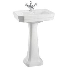 a white pedestal sink with a faucet on the side and a chrome faucet